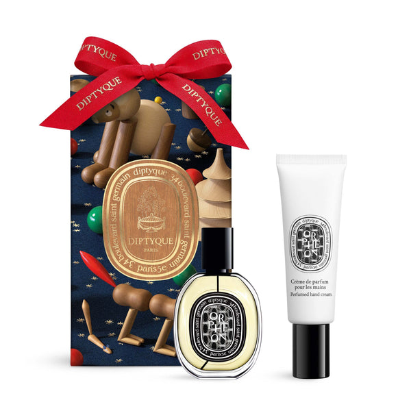 Diptyque holiday Surprise Fragrance Set with Orphéon Eau de Parfum and perfumed hand cream beside a ribboned gift box