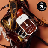Touchland hand sanitizer mist in burgundy leather bag with sunglasses and tissues, TSA approved