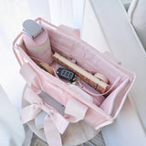 Ballet pink tote organizer insert held open showing water bottle, keys, and accessories inside