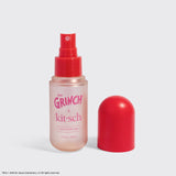 The Grinch x Kitsch Cherry Cheer Hair Perfume spray bottle with red cap and matching cap cover