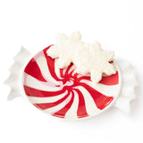 Red and white peppermint swirl dessert plate topped with whipped cream