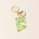 Green floral acrylic sorority letter keychain with gold hardware on neutral background