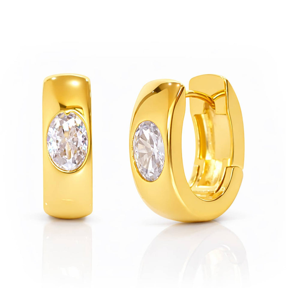 Gold huggie earrings with oval clear cubic zirconia stones, front and side view