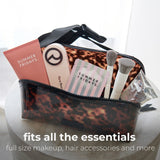 Tortoiseshell cosmetic bag filled with makeup, brushes, and Summer Fridays products