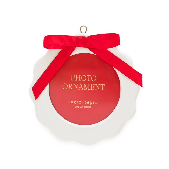 Red and white circular photo ornament with red ribbon bow by Sugar Paper Los Angeles