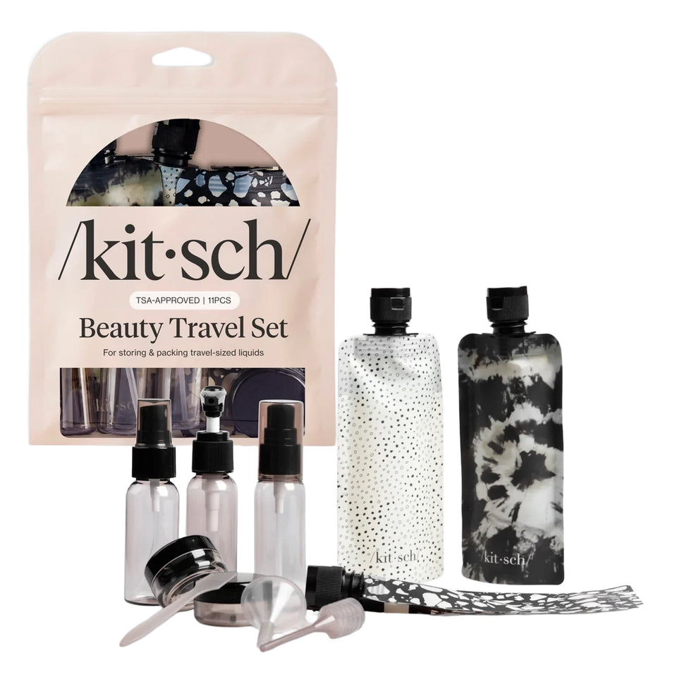 Kitsch Beauty Travel Set with a pink pouch, two patterned bottles, three small clear bottles, and several clear transfer tools on a white background.