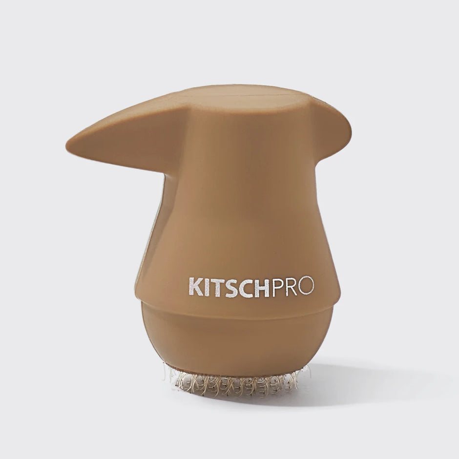 A Kitsch Pro Ponyfull in a matte tan color, featuring the white 'KITSCHPRO' logo on the front and a clear silicone bristle base, set against a light gray background.
