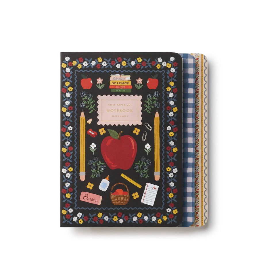 Rifle Paper Co. Schoolhouse notebook with dark cover, colorful floral border, apple and school supplies design
