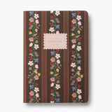 Rifle Paper Co. floral notebook with brown cover, pink label, and ruled pages