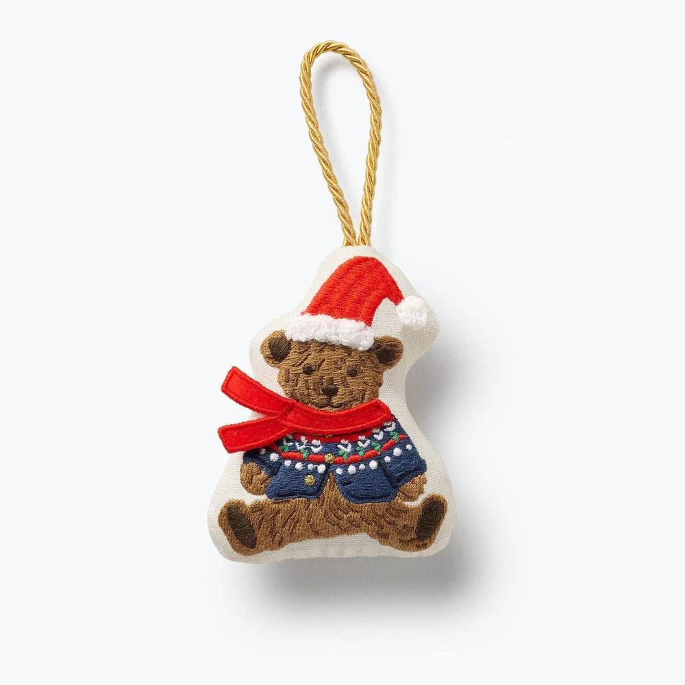 Brown teddy bear Christmas ornament wearing Santa hat and red bow with knit sweater detail