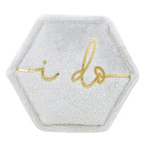 Velvet hexagonal ring box with 'I do' gold embroidery on light gray felt