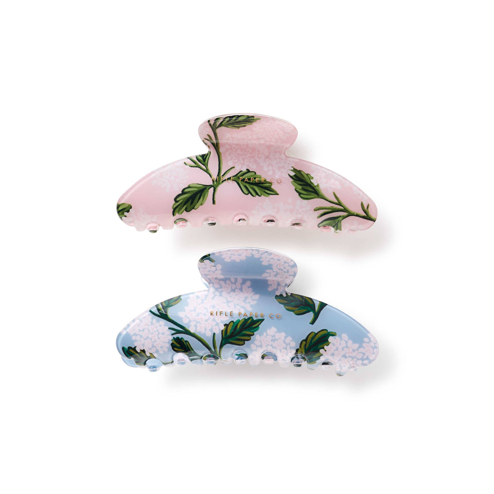 Two floral-patterned hair clips on a white background