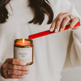 Red rechtsargeable lighter by Sweet Water Decor held by woman in white sweater with engagement ring