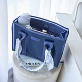 Navy CASE-MATE tote organizer displayed on white surface with contents visible, styled setting
