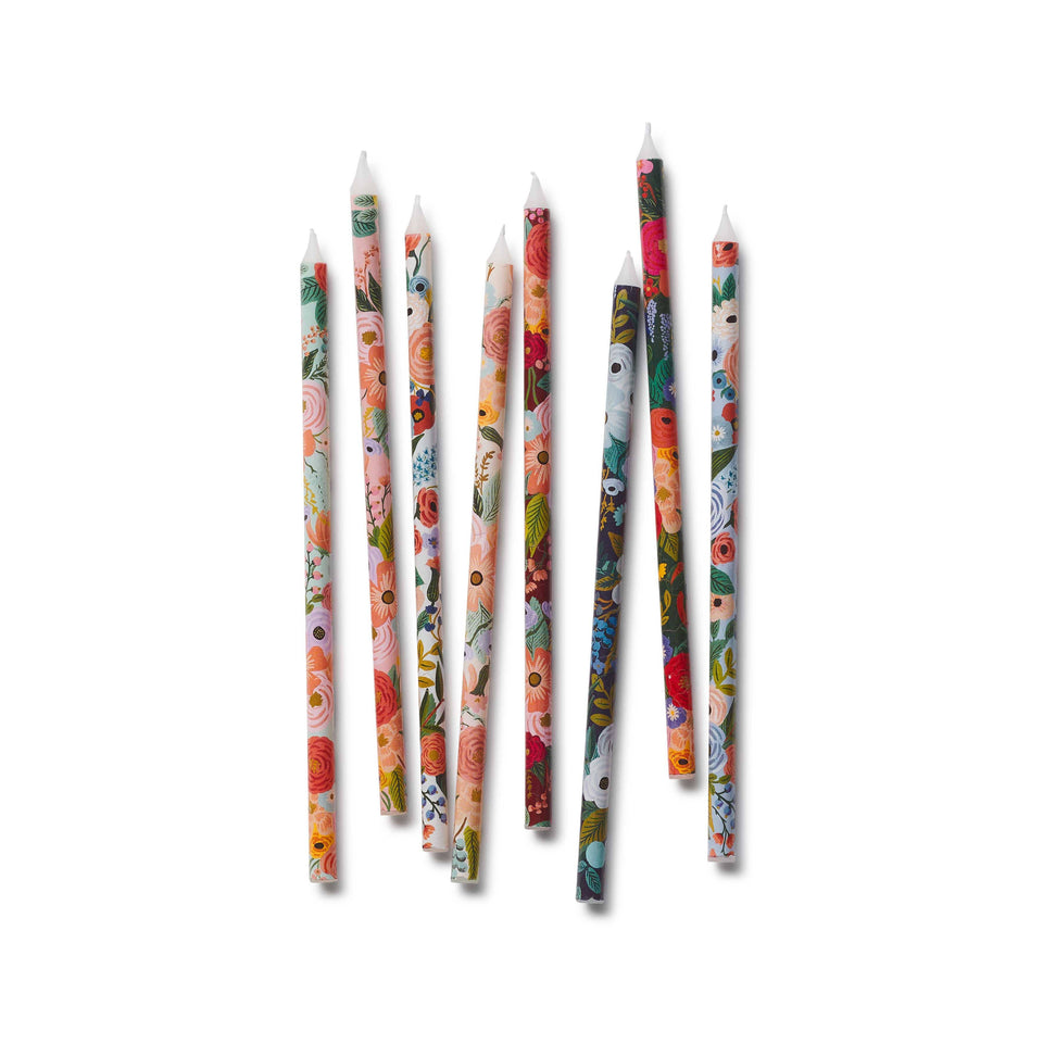 Set of floral-patterned candles on a white background
