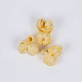 Poppy hand-crafted popcorn with caramelized onion and sage seasoning on white background