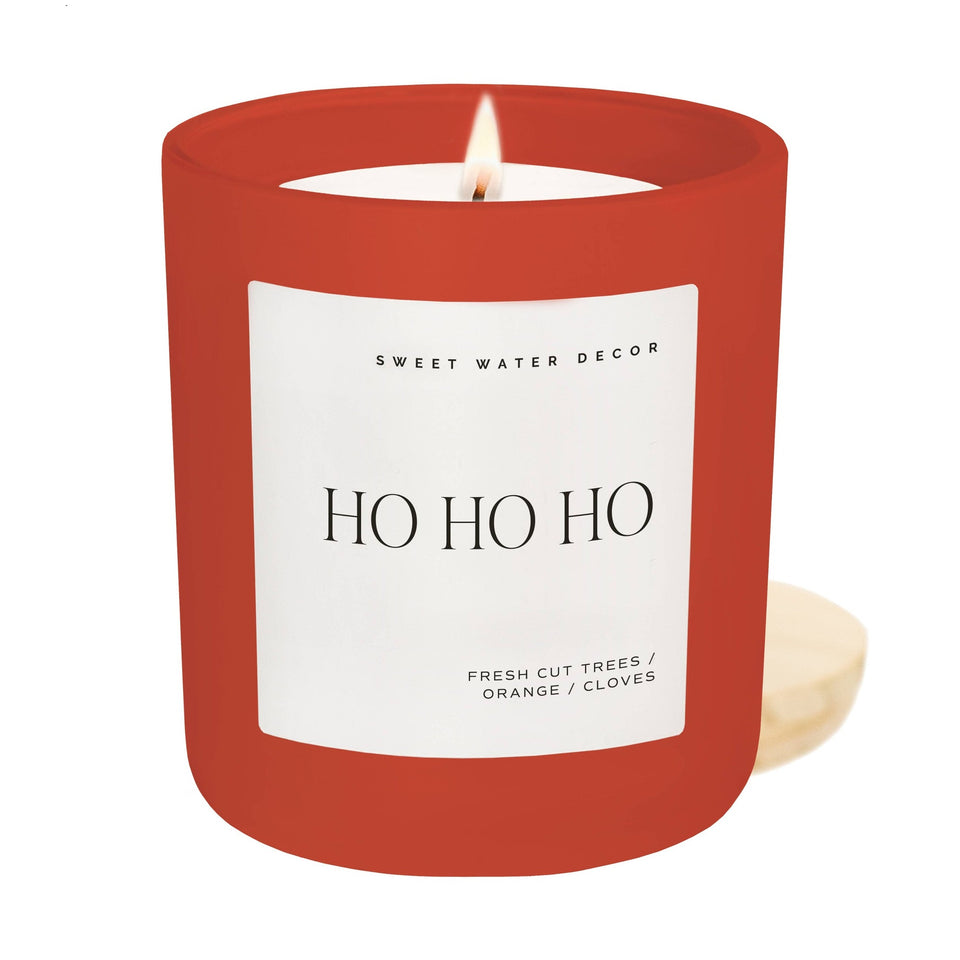 Sweet Water Decor Ho Ho Ho red soy candle with fresh cut trees, orange and cloves scent