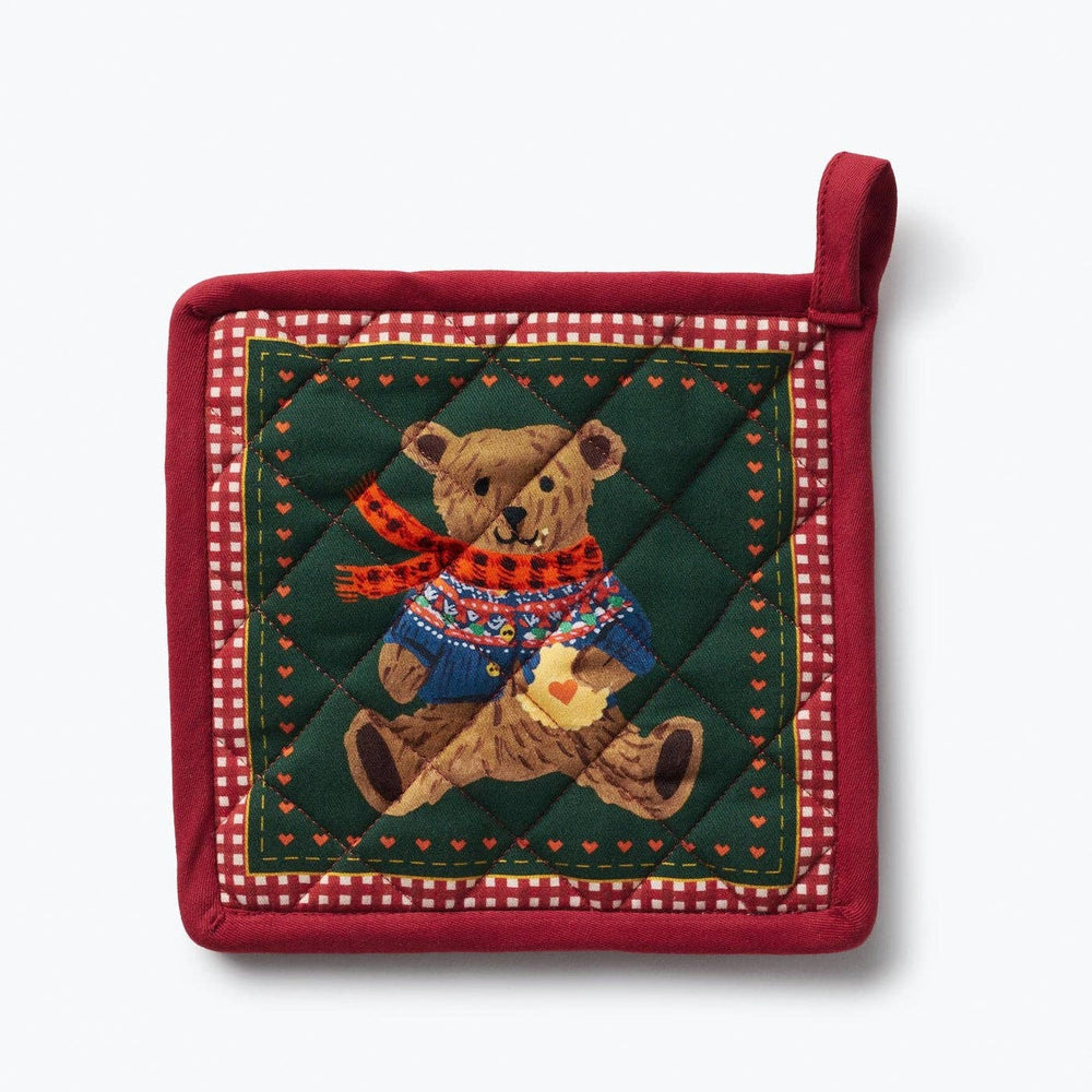 Red quilted pot holder with festive teddy bear design wearing sweater and scarf on green background