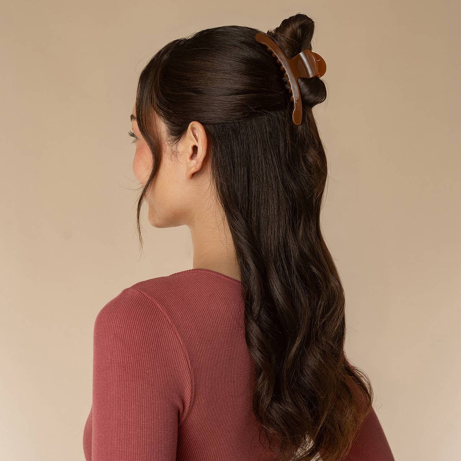 Recycled plastic large arched hair clip in tortoiseshell worn in half-up hairstyle
