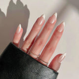 Hand with long, manicured nails wearing a black sleeve against a neutral background
