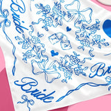 White bride hair scarf with blue floral patterns, bows, and hearts for bachelorette parties