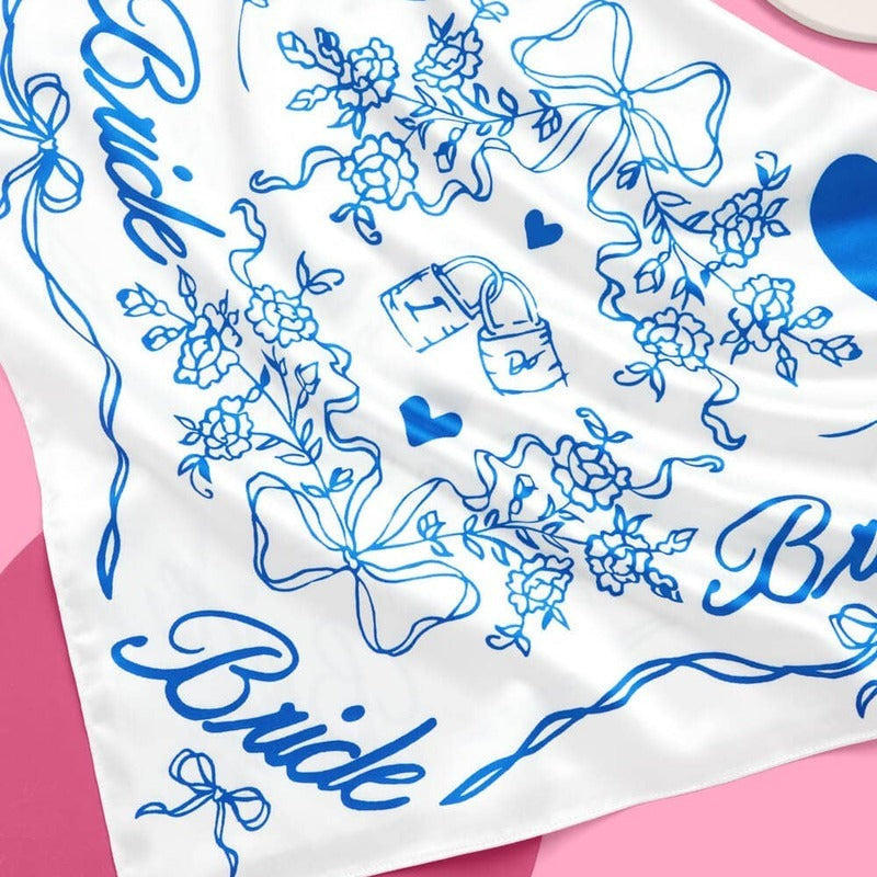White bride hair scarf with blue floral patterns, bows, and hearts for bachelorette parties