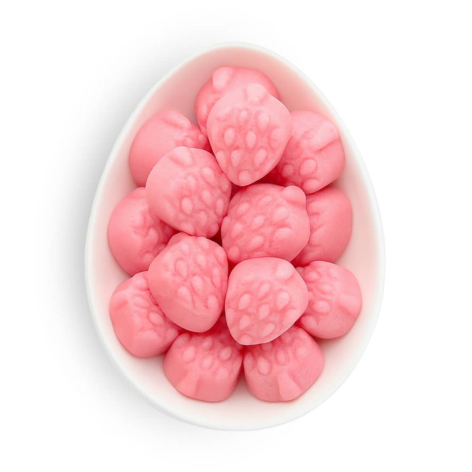 Pink strawberry gummies in white teardrop-shaped candy container from Sugarfina