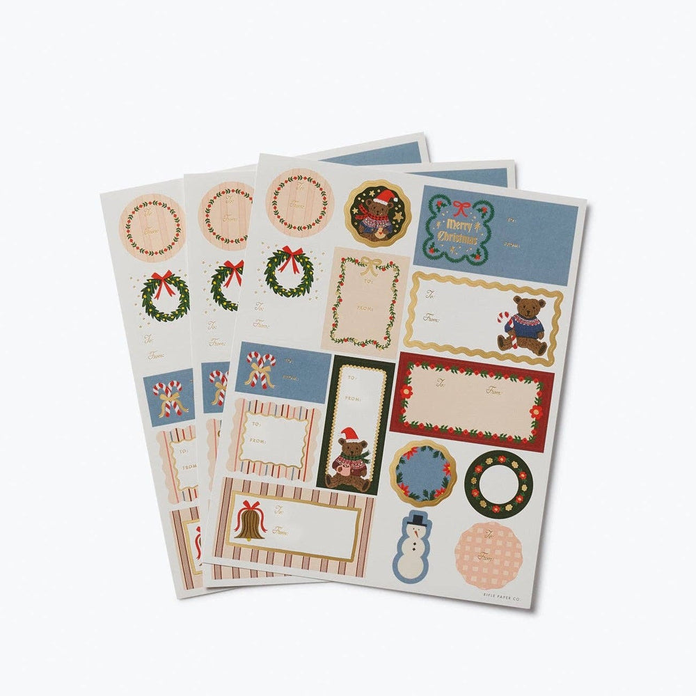 Three sheets of Rifle Paper Co. Christmas sticker and label sheets with festive holiday designs