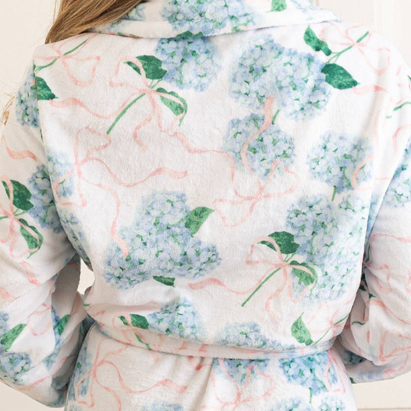 Woman wearing Hydrangea Ribbons Luxe Robe with blue and pink floral pattern