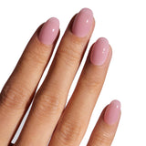 Hand with pink nail polish on a white background
