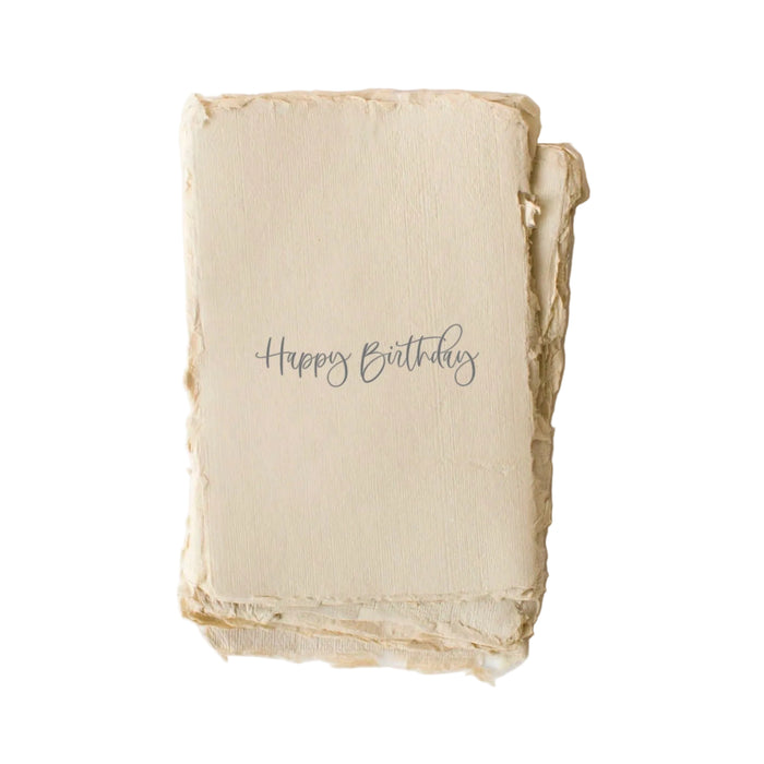 Happy Birthday greeting card with handwritten script text on cream textured paper with raw edges