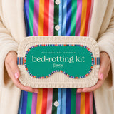 Woman holding colorful Pinch Provisions bed-rotting kit self-care gift in cream cardigan