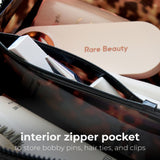 Tortoiseshell cosmetic bag with open zipper pocket showing storage for bobby pins and hair accessories