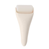 Ivory ice roller by Pinch Provisions with rounded top and tapered cone-shaped handle on white background
