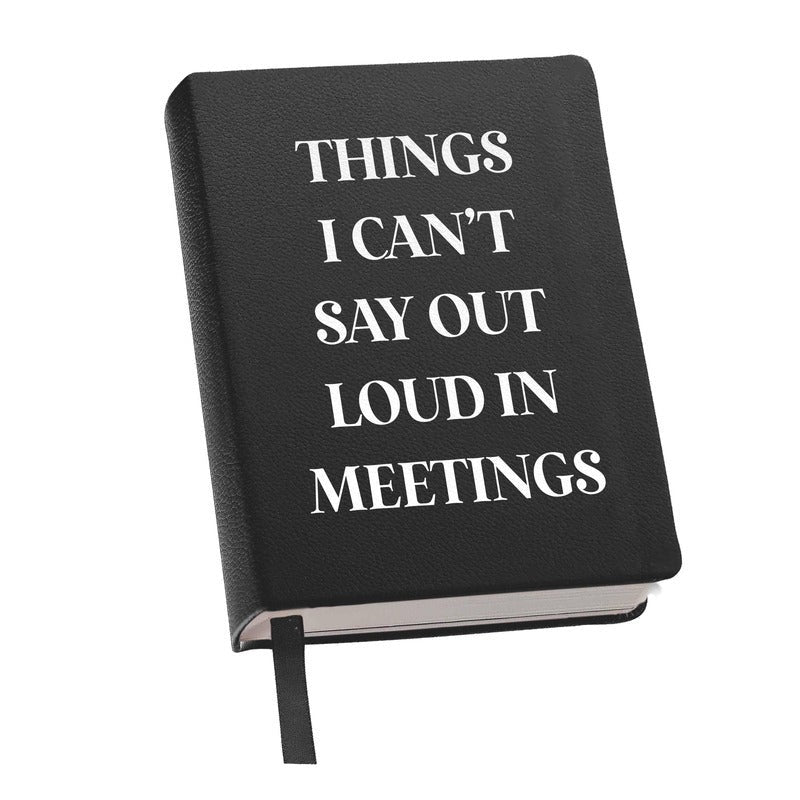 Black leather journal with white text reading 'Things I Can't Say Out Loud In Meetings'