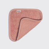 Kitsch microfiber face towel in terracotta pink, folded on white background