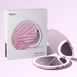 FANCII Mini Taylor compact mirror with LED light in blush zebra stripe pattern, shown open and closed