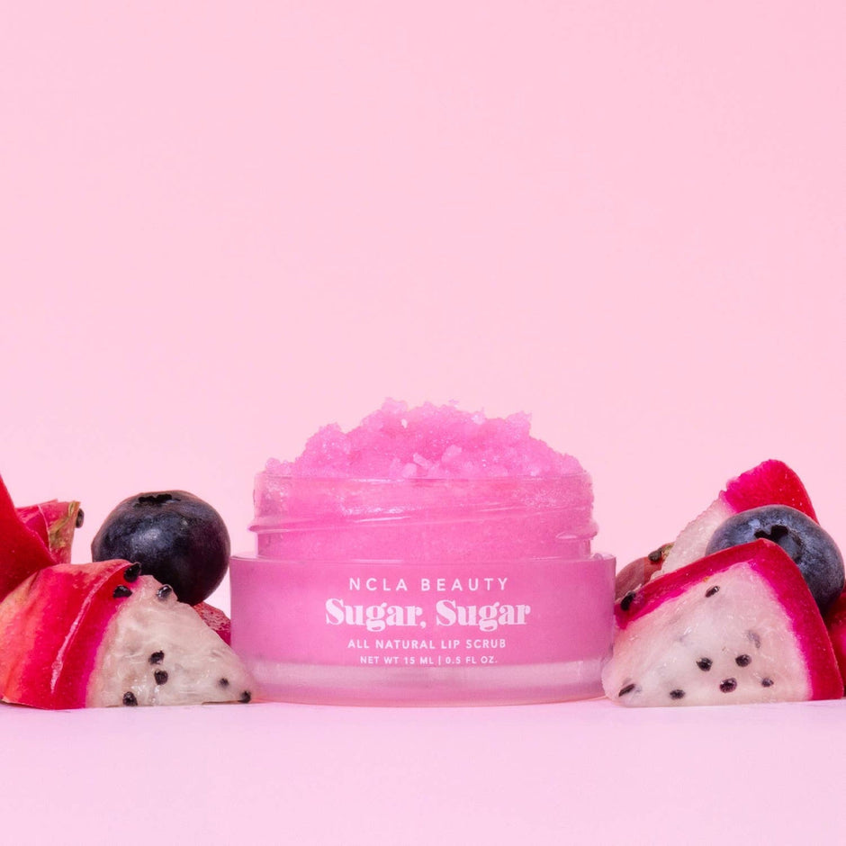 NCLA Beauty Sugar Sugar dragonfruit acai lip scrub in pink jar with fresh berries on pink background
