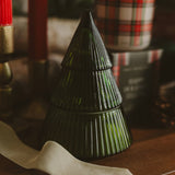Fraser Fir Soy Candle in decorative glass tree jar displayed on wooden table with holiday decor