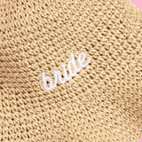 Beige straw bucket hat with white 'BRIDE' embroidered text, bridal headwear