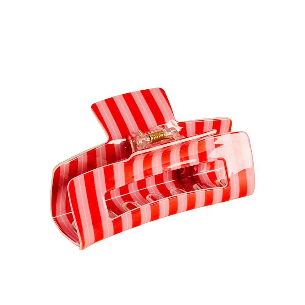 Red and white striped claw clip with metallic clasp on white background