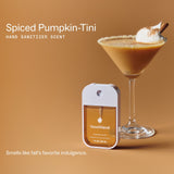 Touchland hand sanitizer displayed next to a spiced pumpkin cocktail on tan background