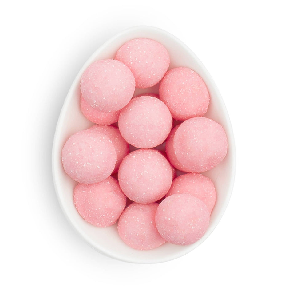 Sugarfina pink bonbons in white oval dish, sugar-coated candies top view