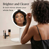 LED lighted 8-inch travel mirror with woman applying makeup, highlighting bright clear reflection