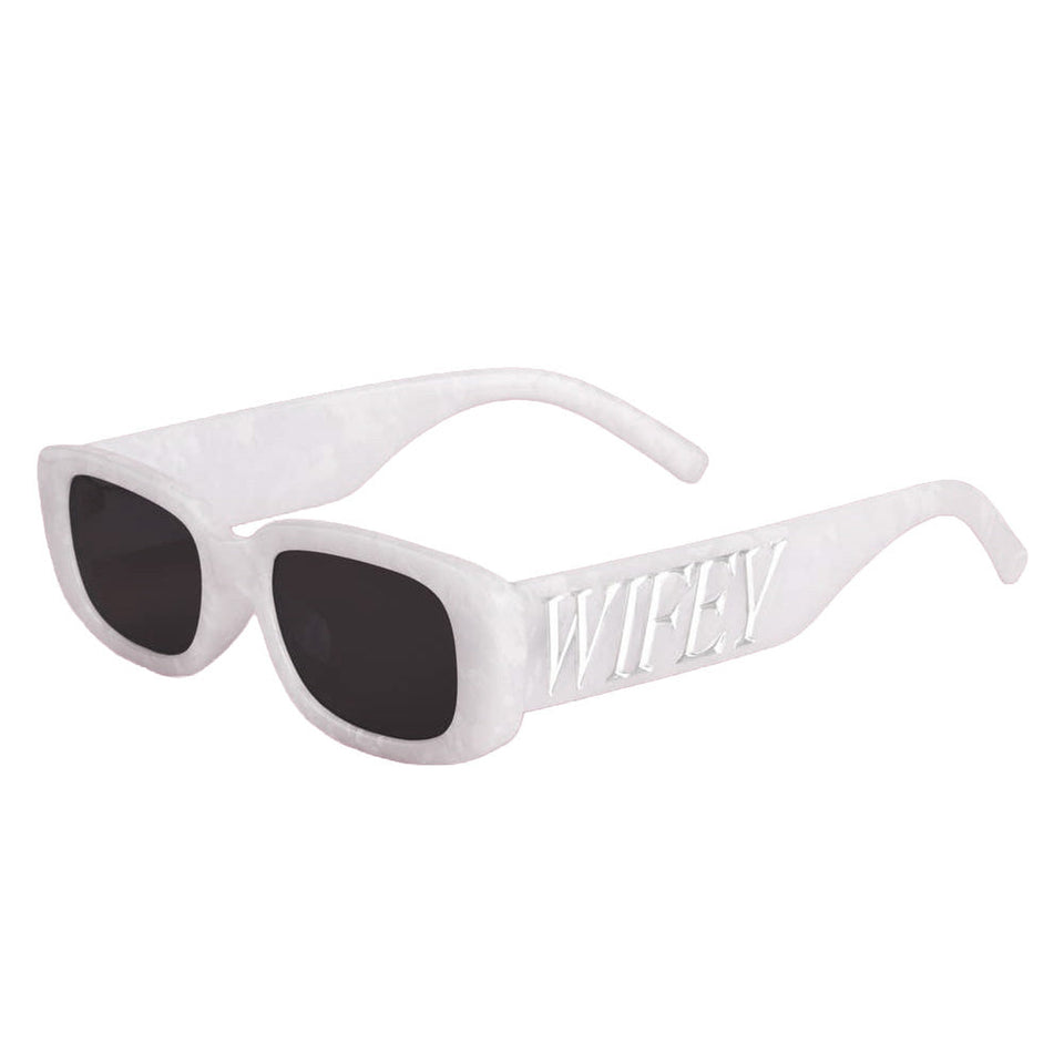 White Wifey sunglasses with dark lenses and embossed temple detail on neutral background
