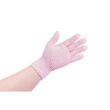 Pink exfoliating body gloves on model's hand against white background