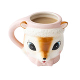 Pink ceramic reindeer mug with gold ears and facial features, filled with coffee