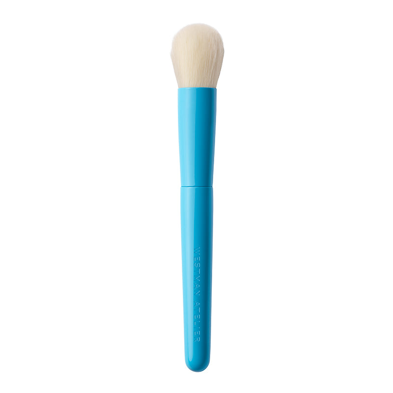 Blue makeup brush with white bristles on a white background