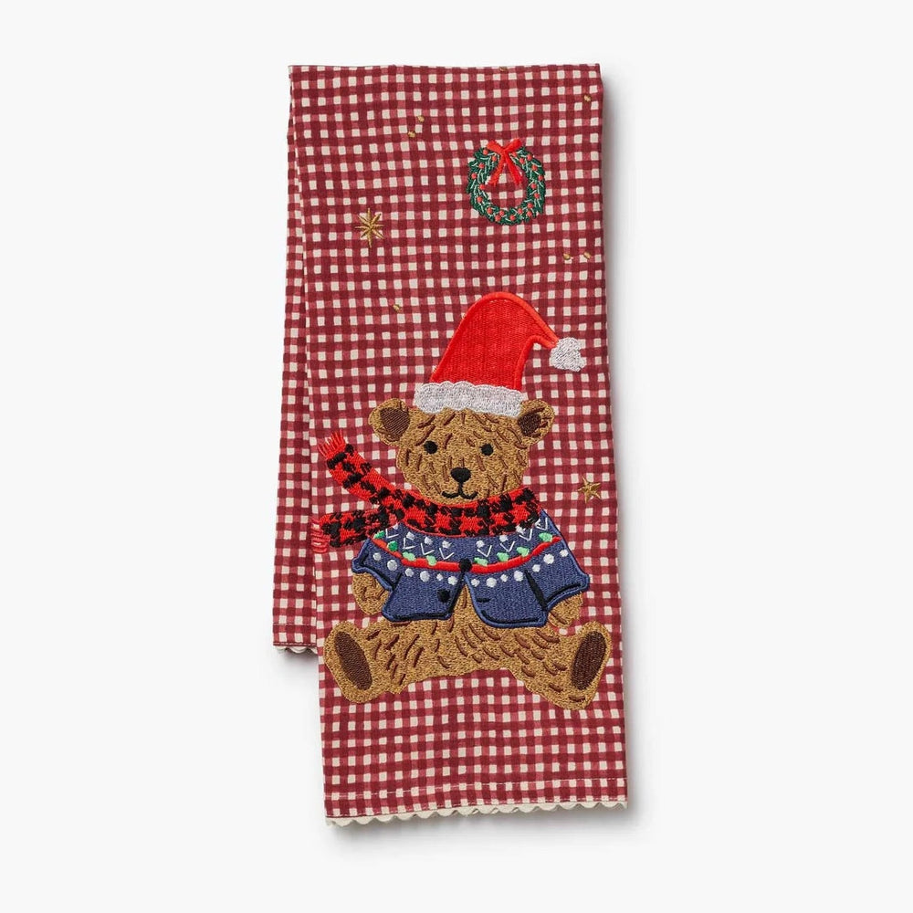 Red gingham tea towel with embroidered teddy bear wearing Santa hat and sweater