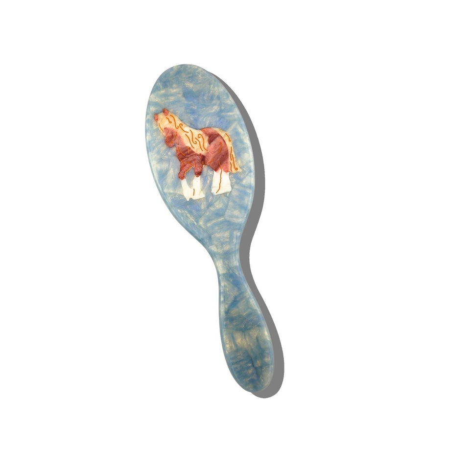 Solar Eclipse hand-painted horse hair brush with blue and red design on white background